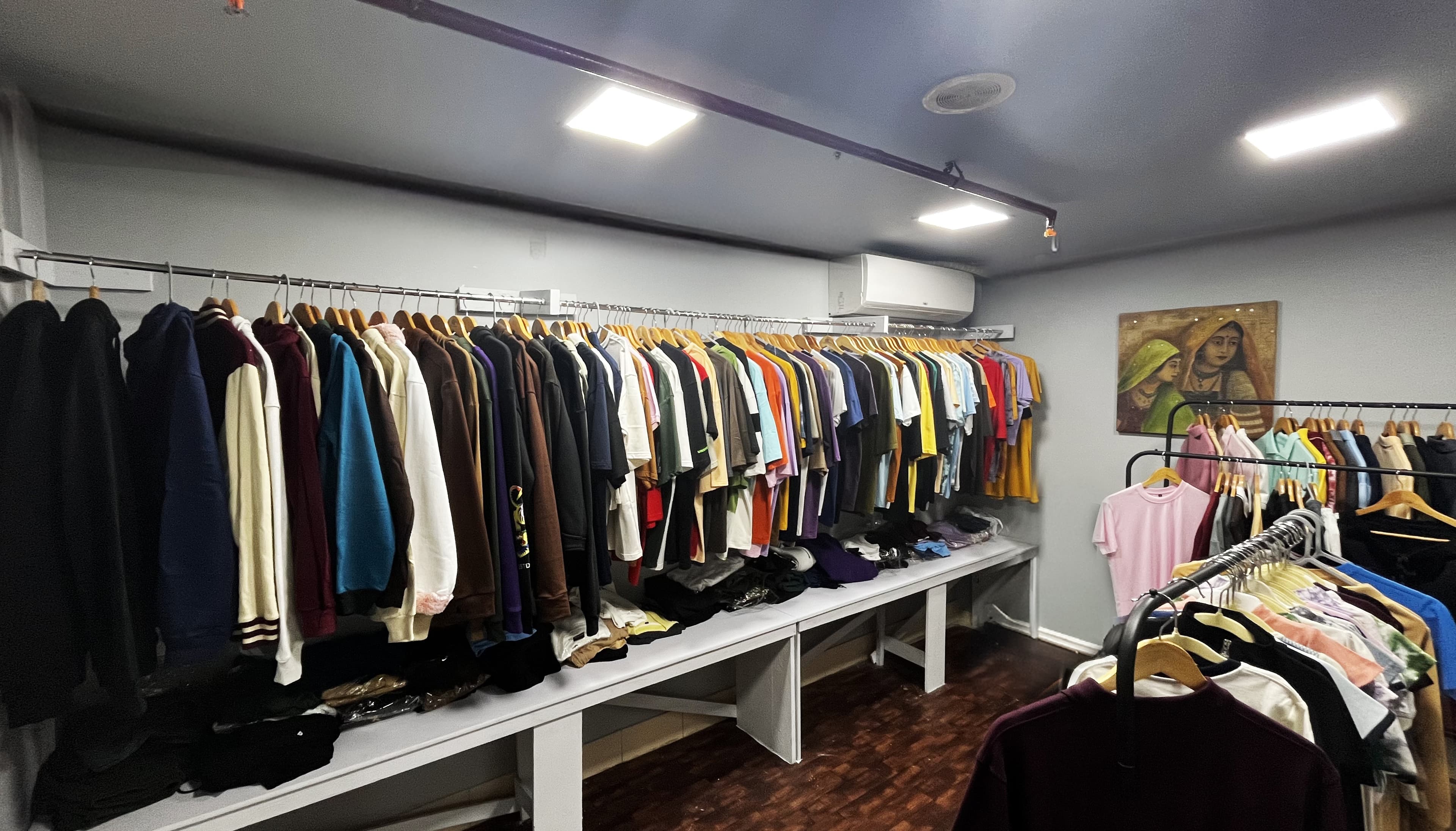 A rail of blank ready-stock garments in many colours at the Plakads office